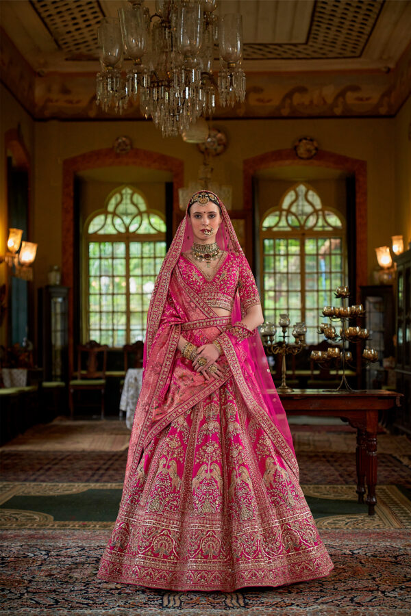 Majestic Rani Pink Bridal Lehenga Choli with Dual Dupatta Style and Intricate Gold Zari Embroidery